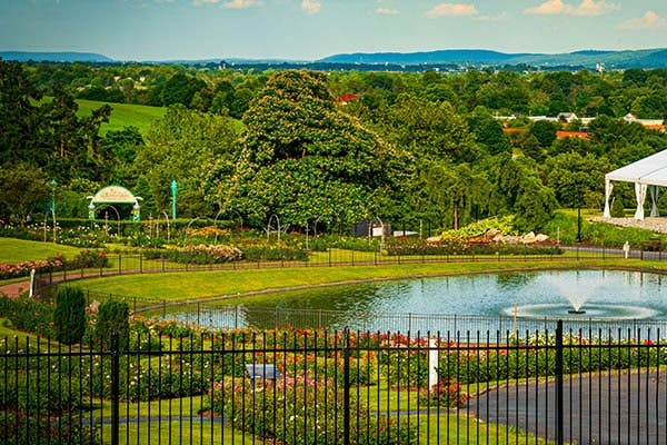 Beautiful garden view at Hershey Gardens in the Hershey area, featuring a tranquil pond, vibrant flowers, and lush greenery