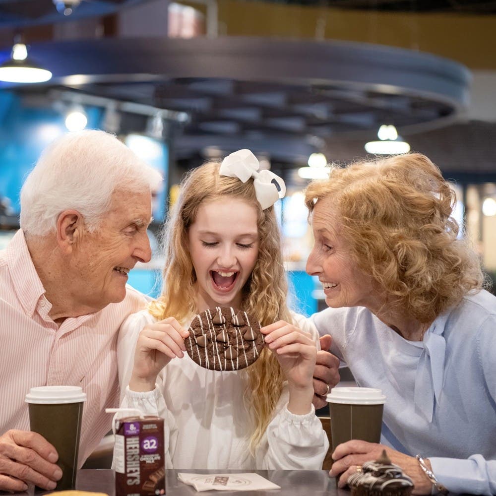 Child and grandparents with cookies